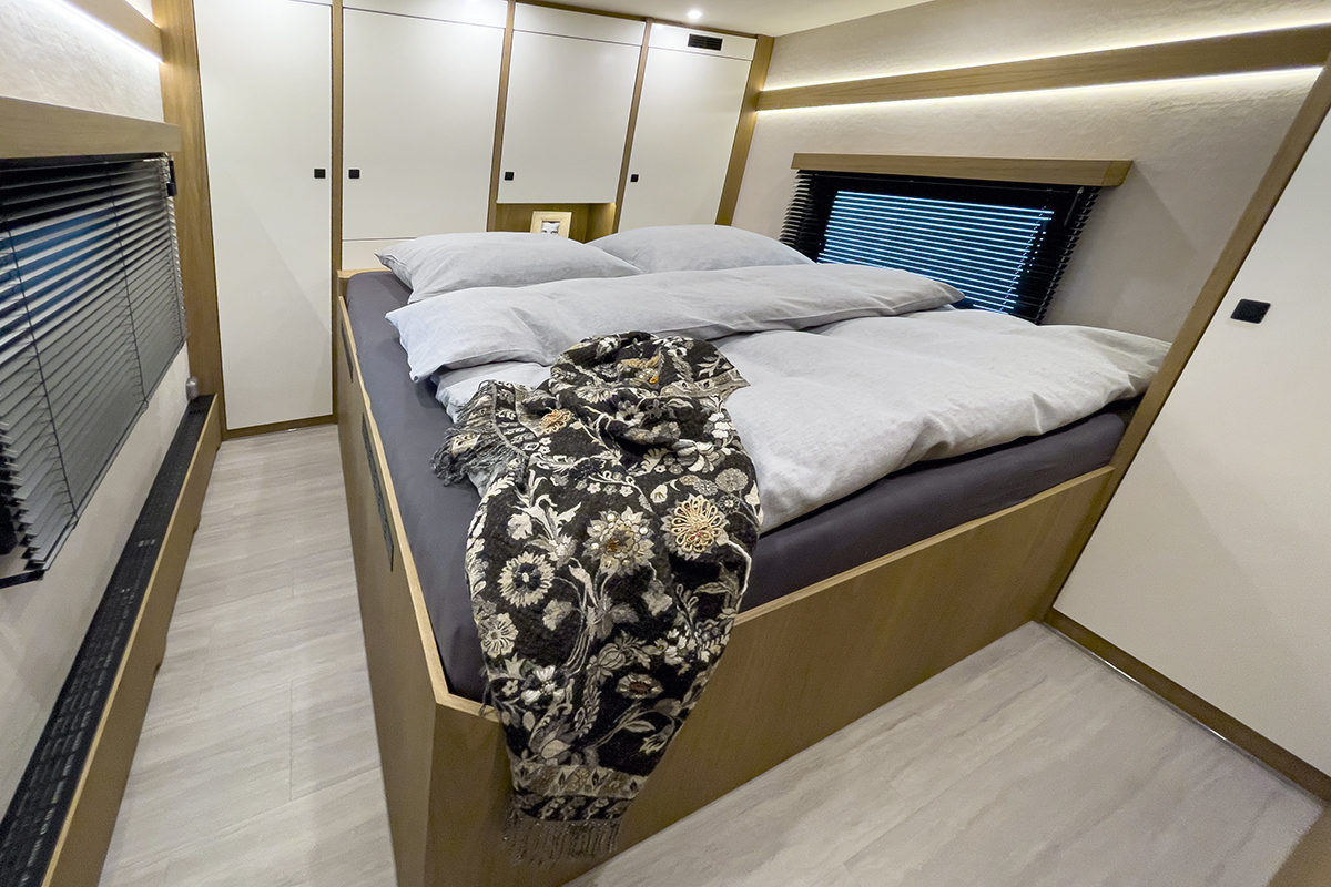 Walnut fine wood interior in a luxury motor home bedroom